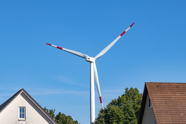 Residential buildings in Hamburg with a wind turbine in the background