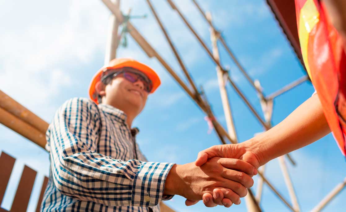 Engineer contractor shaking hands at break down house construction site working architecture planning in sunny weather day.